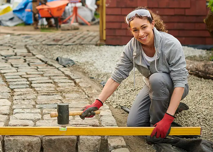 A woman with goggles at a construction site.